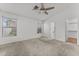 Bright, airy bedroom with neutral carpet, a ceiling fan, and multiple windows for natural light at 11405 W Windsor Ave, Avondale, AZ 85392
