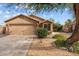 Charming single-story home featuring a two-car garage and desert landscaping for low maintenance at 11405 W Windsor Ave, Avondale, AZ 85392