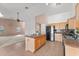 Open-concept kitchen with a center island, black appliances, and tile flooring at 11405 W Windsor Ave, Avondale, AZ 85392