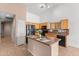 Well-equipped kitchen featuring an island, modern appliances, tile floors, and warm cabinetry at 11405 W Windsor Ave, Avondale, AZ 85392