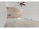 Open living space with neutral carpet, large windows, and ceiling fan for comfortable living at 11405 W Windsor Ave, Avondale, AZ 85392