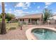 Backyard in-ground swimming pool is surrounded by rock landscaping and has great mountain views at 11405 W Windsor Ave, Avondale, AZ 85392