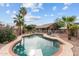 In-ground swimming pool and jacuzzi surrounded by lush landscaping and a privacy fence at 11405 W Windsor Ave, Avondale, AZ 85392