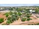 Scenic aerial view featuring community garden plots, lush farmland, and surrounding residential properties at 1316 S Minneola Ln, Gilbert, AZ 85296