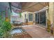 Cozy backyard featuring a shade sail, daybed, small pond with flora, and a sliding glass door at 1316 S Minneola Ln, Gilbert, AZ 85296