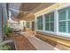 Spacious backyard with shade sail, daybed, pond, and hardscape leading to windows and sliding glass door at 1316 S Minneola Ln, Gilbert, AZ 85296