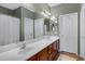 Bathroom with double sinks, dark wood cabinets, large mirror and shower at 1316 S Minneola Ln, Gilbert, AZ 85296