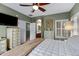 Bright bedroom featuring a ceiling fan, mounted TV, and a bathroom entrance at 1316 S Minneola Ln, Gilbert, AZ 85296