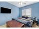 Blue bedroom with a television and a window with white shutters at 1316 S Minneola Ln, Gilbert, AZ 85296