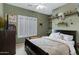 Bedroom featuring modern decor, shelves, window with plantation shutters, and ceiling fan at 1316 S Minneola Ln, Gilbert, AZ 85296