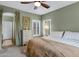 Bedroom with green walls, plush carpet, and large window with shutters at 1316 S Minneola Ln, Gilbert, AZ 85296