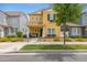 Charming two-story home featuring a yellow facade, manicured landscaping, and a welcoming front porch with seating at 1316 S Minneola Ln, Gilbert, AZ 85296