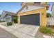 Two-story home with a grey roll-up door and a driveway at 1316 S Minneola Ln, Gilbert, AZ 85296