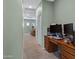 Hallway featuring a desk and 2 computer monitors, leading to another room at 1316 S Minneola Ln, Gilbert, AZ 85296