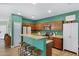 Charming kitchen features stainless appliances, wood cabinets, granite countertops and seating at the bar at 1316 S Minneola Ln, Gilbert, AZ 85296