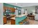 View of the kitchen with stainless steel appliances, wood cabinets and a breakfast bar at 1316 S Minneola Ln, Gilbert, AZ 85296