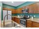 Well-equipped kitchen featuring stainless steel appliances, granite countertops and a double sink at 1316 S Minneola Ln, Gilbert, AZ 85296