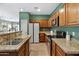 Spacious kitchen with stainless appliances, granite counters, and plenty of wood cabinets for storage at 1316 S Minneola Ln, Gilbert, AZ 85296