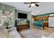 Bright living room featuring an entertainment system, an aquarium and a partial view of the kitchen at 1316 S Minneola Ln, Gilbert, AZ 85296