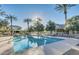 Community pool with lounge chairs and palm trees, perfect for relaxation and enjoying sunny days at 1316 S Minneola Ln, Gilbert, AZ 85296