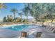 Relaxing community pool with lounge seating, palm trees, and well-maintained landscaping at 1316 S Minneola Ln, Gilbert, AZ 85296