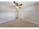 Bedroom features neutral paint, carpet flooring, white closet doors and ceiling fan at 1320 E Butler Dr, Phoenix, AZ 85020