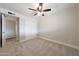 Bedroom features neutral paint, carpet flooring, white closet doors and ceiling fan at 1320 E Butler Dr, Phoenix, AZ 85020