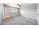 Cozy carpeted bedroom with ceiling fan and a window overlooking the yard at 1320 E Butler Dr, Phoenix, AZ 85020