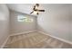 Bedroom with ceiling fan, neutral walls, carpet flooring and bright window at 1320 E Butler Dr, Phoenix, AZ 85020