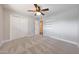 This bedroom features a ceiling fan, carpeted floor and built in shelving at 1320 E Butler Dr, Phoenix, AZ 85020
