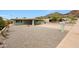 Single story home features an arid front yard and a covered driveway, with mountain views at 1320 E Butler Dr, Phoenix, AZ 85020