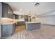 Modern kitchen featuring a central island, gray cabinets, granite counters, and stainless steel appliances at 1320 E Butler Dr, Phoenix, AZ 85020