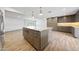 Spacious kitchen with center island, gray cabinetry, stainless steel appliances, and wood look flooring at 1320 E Butler Dr, Phoenix, AZ 85020
