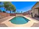 Backyard with a refreshing pool, patio, and lush landscaping, creating the perfect space for outdoor enjoyment and entertaining at 14298 W Amelia Ave, Goodyear, AZ 85395