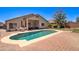 Private backyard with a sparkling pool, brick patio, and outdoor dining space at 14298 W Amelia Ave, Goodyear, AZ 85395