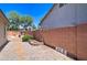 Exterior shot of a backyard featuring a rock border, block wall and desert landscaping, adding character and low maintenance at 14298 W Amelia Ave, Goodyear, AZ 85395