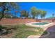 Escape to this backyard oasis with a sparkling pool, charming landscaping, and brick accents, creating a serene retreat at 14298 W Amelia Ave, Goodyear, AZ 85395