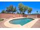 Picture of the backyard featuring a pristine pool with lush greenery, offering a serene retreat for relaxation and recreation at 14298 W Amelia Ave, Goodyear, AZ 85395