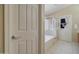 Well-lit bathroom with tile flooring, a glass shower door, and neutral fixtures at 14298 W Amelia Ave, Goodyear, AZ 85395