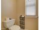 Powder room features a toilet with a new roll of toilet paper nearby at 14298 W Amelia Ave, Goodyear, AZ 85395