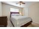 Bedroom with a comfortable bed, ceiling fan, natural lighting, and a chest of drawers at 14298 W Amelia Ave, Goodyear, AZ 85395