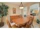 Dining room features a wood table set, a lush green plant, and access to the kitchen at 14298 W Amelia Ave, Goodyear, AZ 85395
