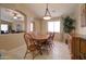 Cozy dining room with wooden table set, natural light, and view of the living area at 14298 W Amelia Ave, Goodyear, AZ 85395