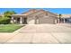 Charming single-story home featuring a two-car garage and well-manicured front yard at 14298 W Amelia Ave, Goodyear, AZ 85395