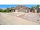 This single-story home has a well-maintained lawn and a spacious two-car garage at 14298 W Amelia Ave, Goodyear, AZ 85395