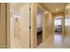 Hallway with neutral walls, neutral tiling and access to a bedroom at 14298 W Amelia Ave, Goodyear, AZ 85395