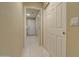 Bright hallway features tile flooring, a closet, and leads to the laundry area, blending functionality with a clean aesthetic at 14298 W Amelia Ave, Goodyear, AZ 85395