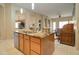 Bright kitchen featuring an island with a sink, modern appliances, and open sight lines to other living areas at 14298 W Amelia Ave, Goodyear, AZ 85395