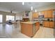 Open kitchen with a granite island, stainless steel appliances, and a breakfast nook, perfect for Gathering meals at 14298 W Amelia Ave, Goodyear, AZ 85395