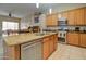 Modern kitchen with stainless steel appliances, a granite island, and a view of the dining area at 14298 W Amelia Ave, Goodyear, AZ 85395